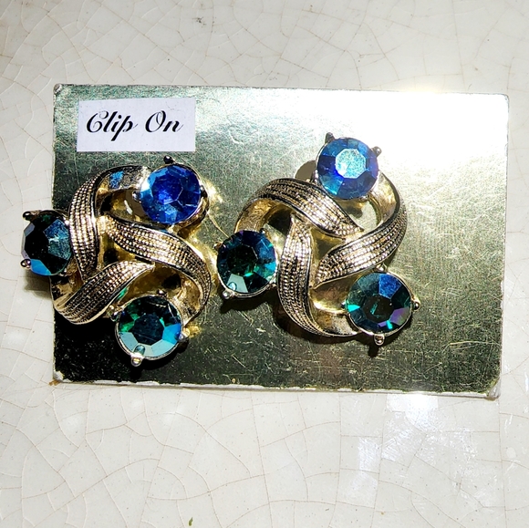 kramer Jewelry - Vintage Kramer gold swirl clip on earrings with brilliant blue faceted stones